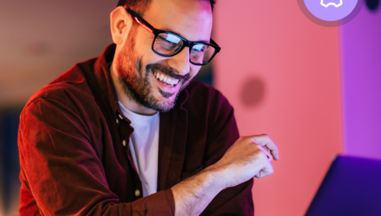 Man with glasses on computer, IT professional role