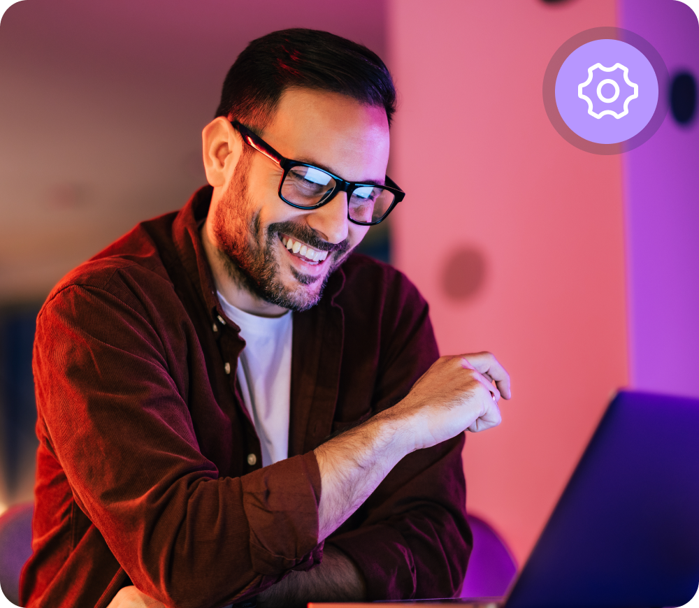 Man with glasses on computer, IT professional role
