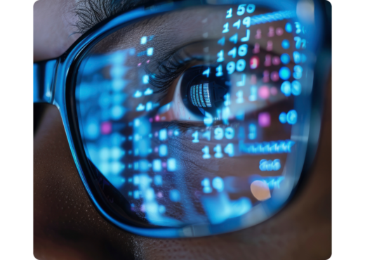 Closeup of glasses reflecting data on a screen